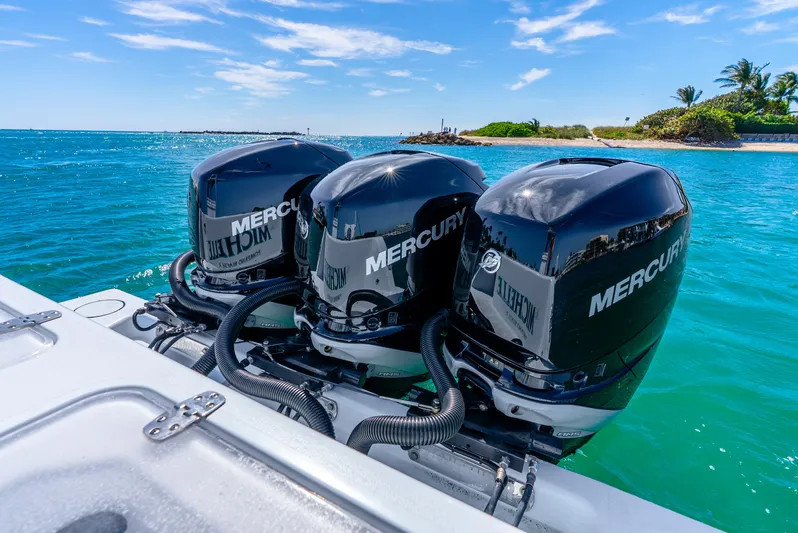  Yacht Photos Pics 2023 Contender 39ST boat with triple Mercury outboard engines on turquoise water.