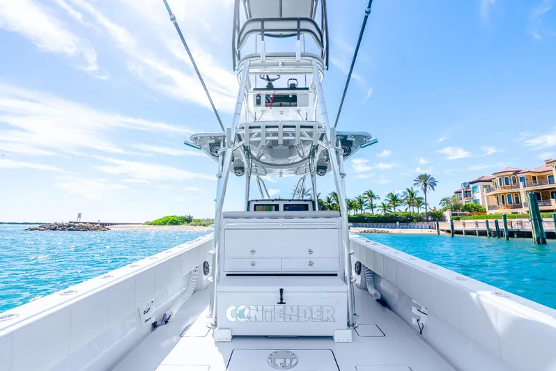  Yacht Photos Pics 2023 Contender 39ST boat on clear blue water, featuring a sleek design and spacious deck.