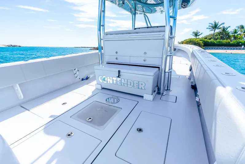  Yacht Photos Pics 2023 Contender 39ST boat deck with storage compartments, set against a scenic ocean backdrop.