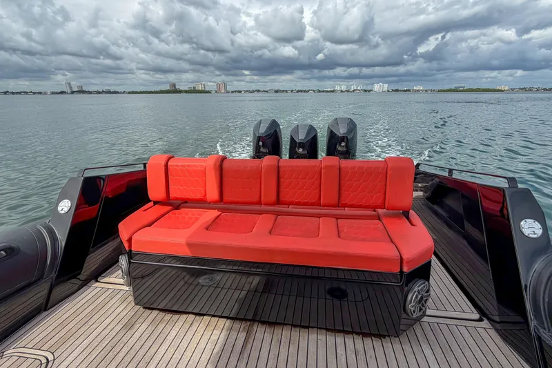  Yacht Photos Pics Luxury Skipper-BSK 42NC boat with red seating, cruising on open water under cloudy skies.