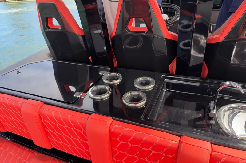  Yacht Photos Pics Red and black interior of 2023 Skipper-BSK 42NC boat with seating and sink.