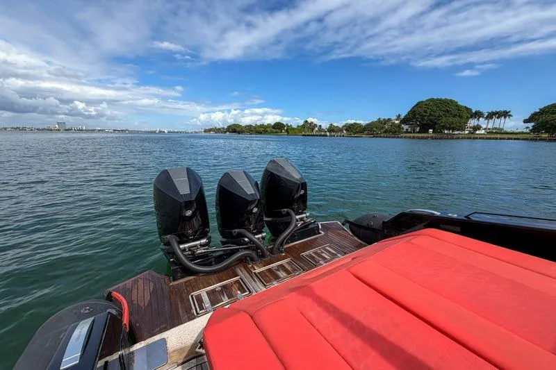  Yacht Photos Pics 2023 Skipper-BSK 42NC boat with triple engines and red seating on a sunny day.
