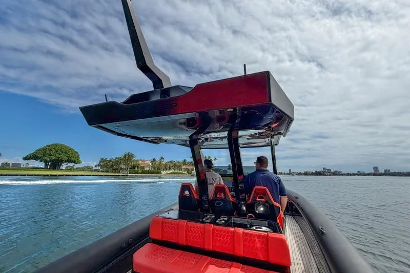  Yacht Photos Pics 2023 Skipper-BSK 42NC boat cruising on a scenic waterway under a partly cloudy sky.