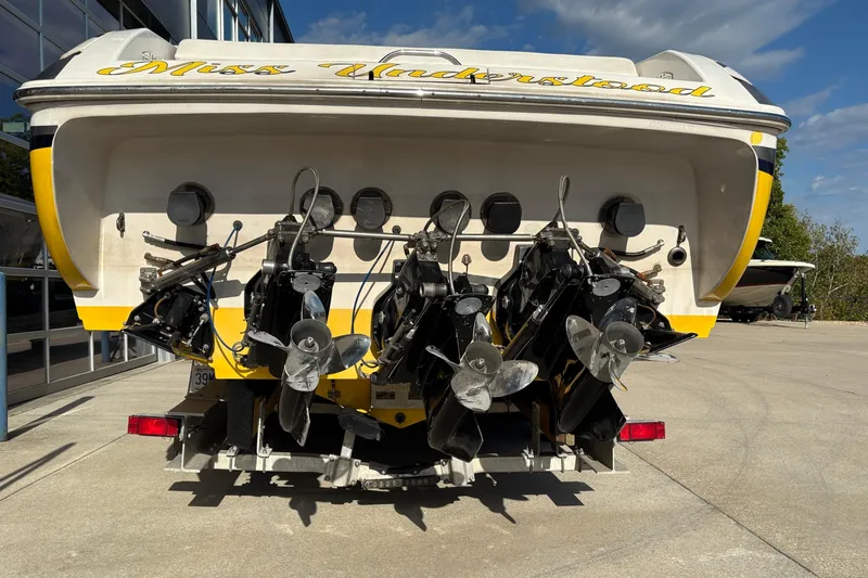  Yacht Photos Pics 2002 Donzi 45 ZX boat with multiple propellers, parked outdoors.