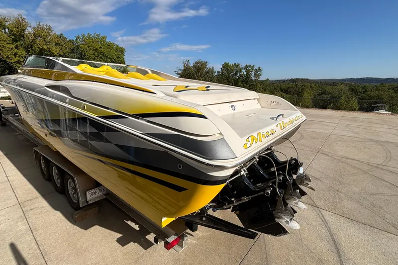  Yacht Photos Pics 2002 Donzi 45 ZX powerboat with yellow accents on a trailer, parked outdoors.