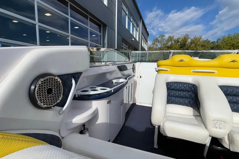  Yacht Photos Pics Interior of 2002 Donzi 45 ZX boat with yellow and white seating, speaker, and cabinetry.