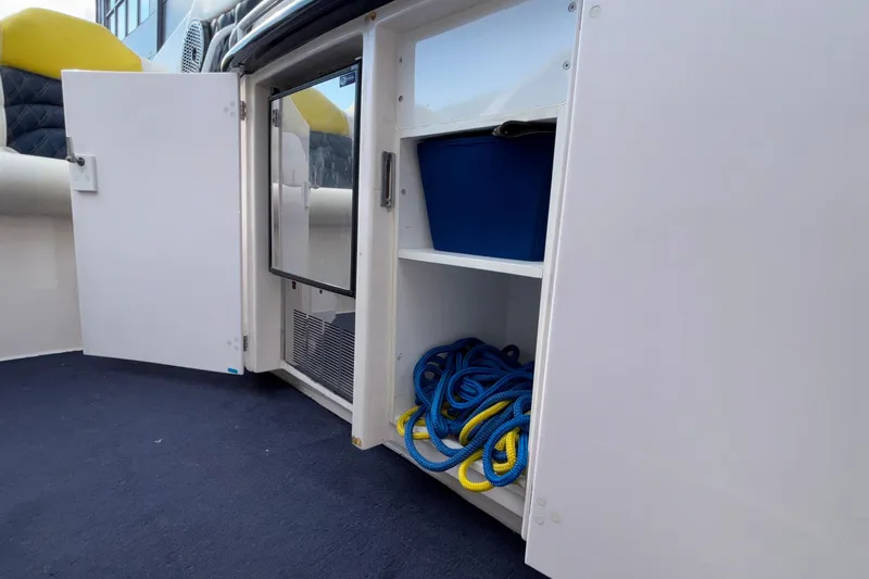  Yacht Photos Pics 2002 Donzi 45 ZX boat storage compartment with ropes and blue container.