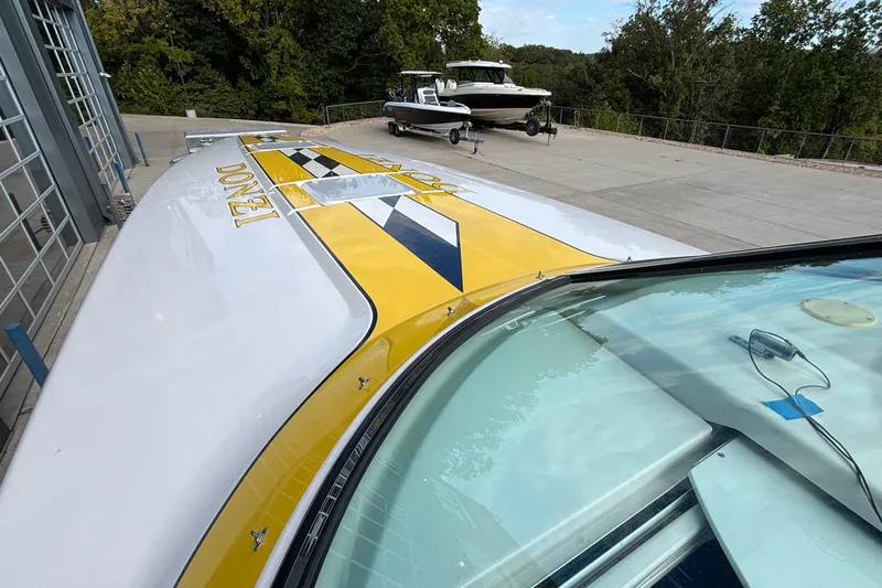  Yacht Photos Pics 2002 Donzi 45 ZX boat with yellow and black design, parked outdoors.