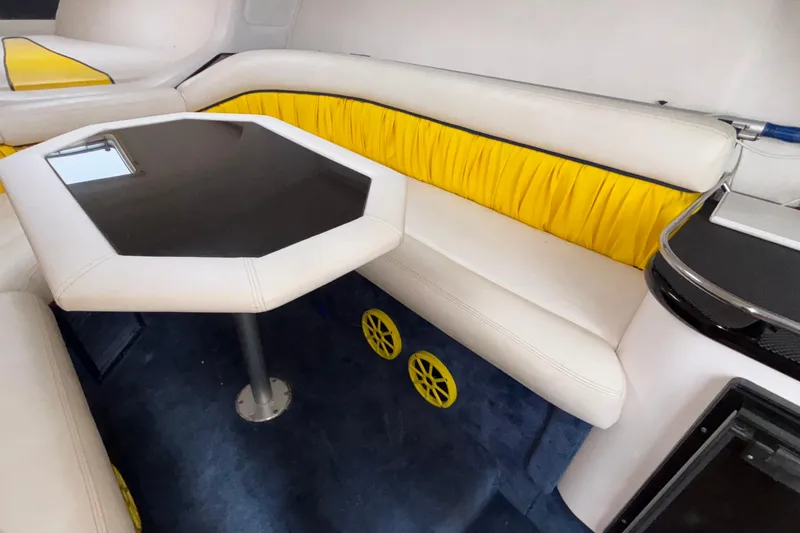  Yacht Photos Pics Interior of 2002 Donzi 45 ZX boat with white and yellow seating, black table.