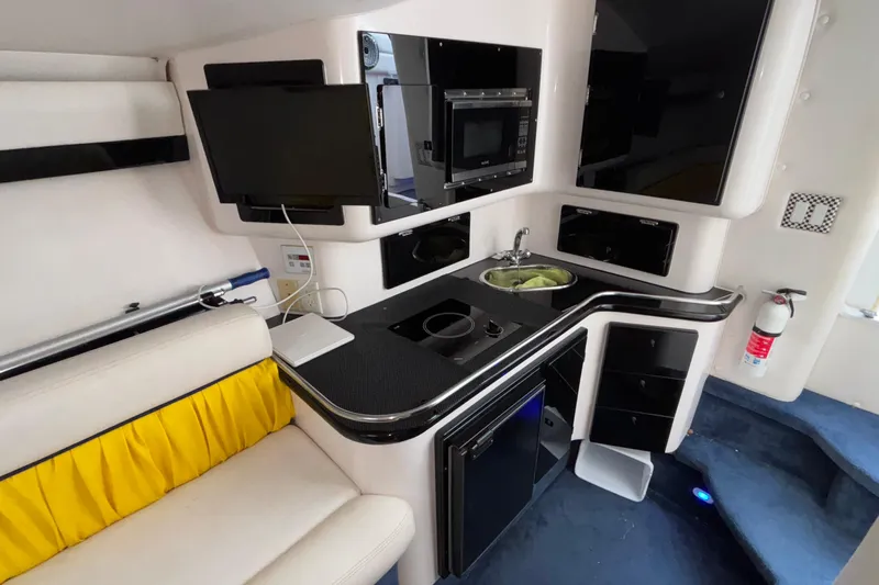  Yacht Photos Pics Interior of 2002 Donzi 45 ZX boat featuring kitchenette, seating, and modern amenities.