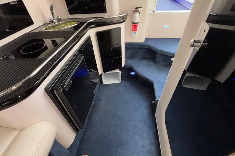  Yacht Photos Pics Interior of 2002 Donzi 45 ZX boat featuring kitchenette and carpeted steps.