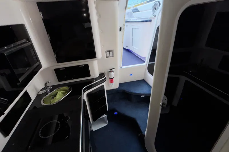  Yacht Photos Pics Interior of 2002 Donzi 45 ZX boat featuring kitchenette and modern amenities.