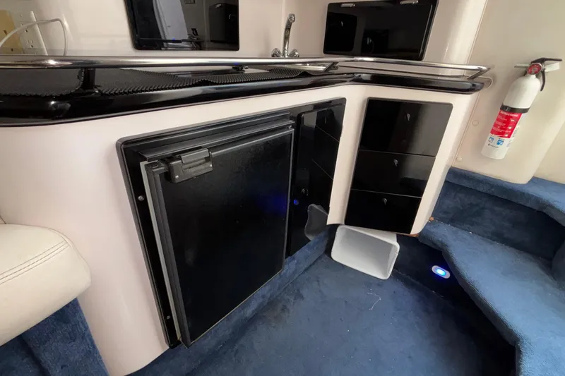  Yacht Photos Pics Interior of a 2002 Donzi 45 ZX boat featuring a compact kitchenette with a fridge.