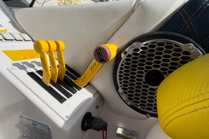  Yacht Photos Pics 2002 Donzi 45 ZX boat controls with yellow levers and speaker detail.