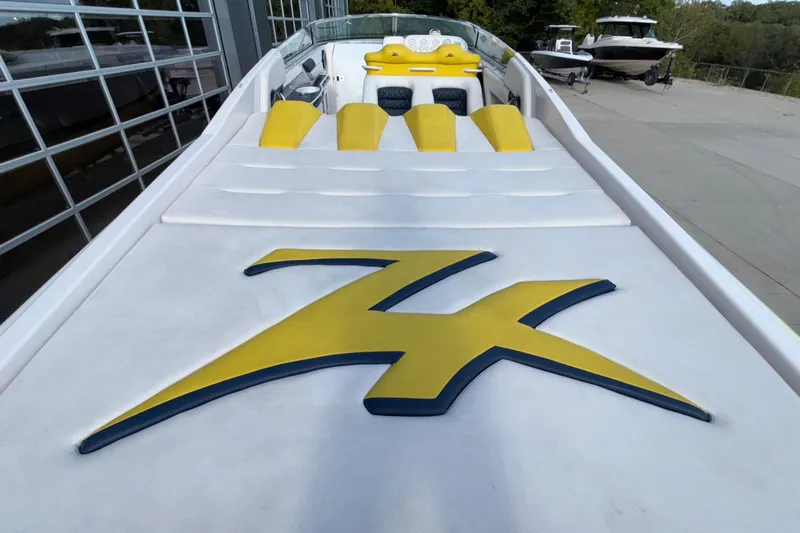  Yacht Photos Pics 2002 Donzi 45 ZX boat with yellow accents and logo, docked outdoors.