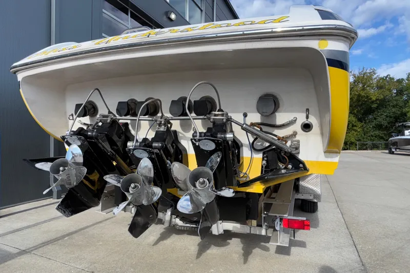  Yacht Photos Pics 2002 Donzi 45 ZX boat with triple propellers, docked outdoors.