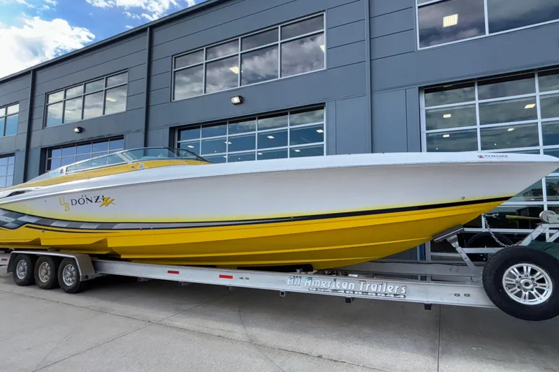  Yacht Photos Pics 2002 Donzi 45 ZX speedboat with yellow and white design on a trailer.