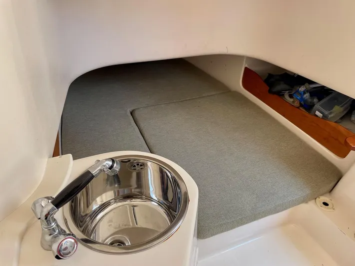  Yacht Photos Pics Interior cabin of 2012 Grady-White Canyon 336 with sink and cushioned seating area.
