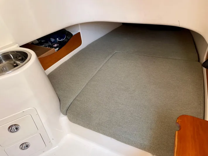  Yacht Photos Pics 2012 Grady-White Canyon 336 cabin interior with carpeted flooring and storage compartments.