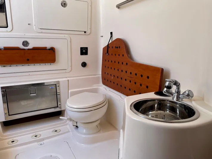  Yacht Photos Pics 2012 Grady-White Canyon 336 boat bathroom with toilet, sink, and storage compartments.
