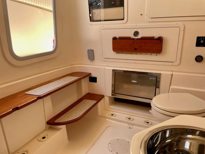  Yacht Photos Pics 2012 Grady-White Canyon 336 boat interior with seating, storage, and toilet.