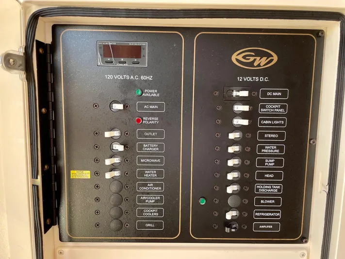  Yacht Photos Pics Electrical panel of a 2012 Grady-White Canyon 336 boat, showing AC and DC switches.