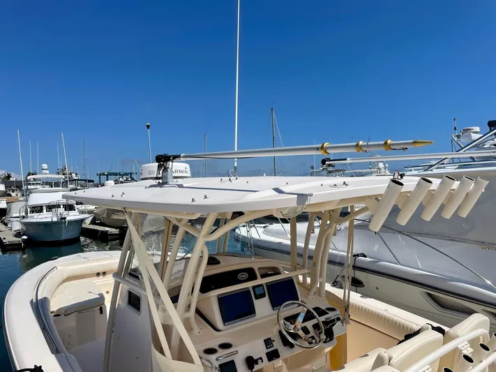  Yacht Photos Pics 2012 Grady-White Canyon 336 boat docked in marina, featuring helm and rod holders.
