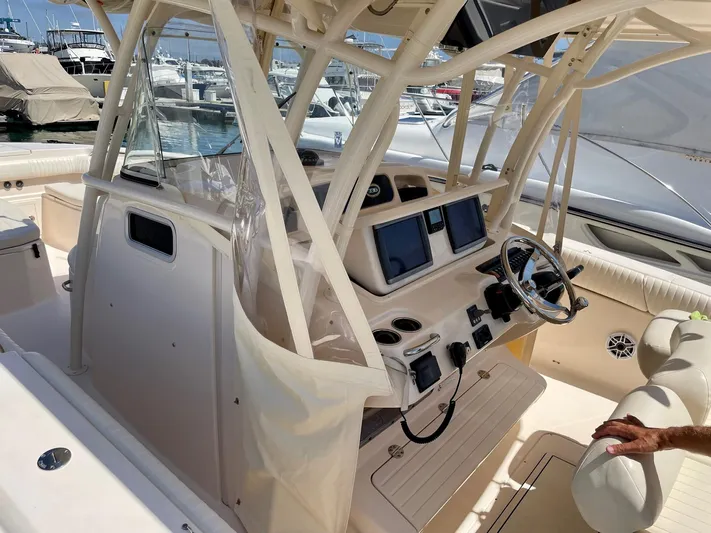  Yacht Photos Pics 2012 Grady-White Canyon 336 boat interior with dual screens and steering wheel at marina.