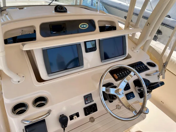  Yacht Photos Pics 2012 Grady-White Canyon 336 helm with dual screens and steering wheel.