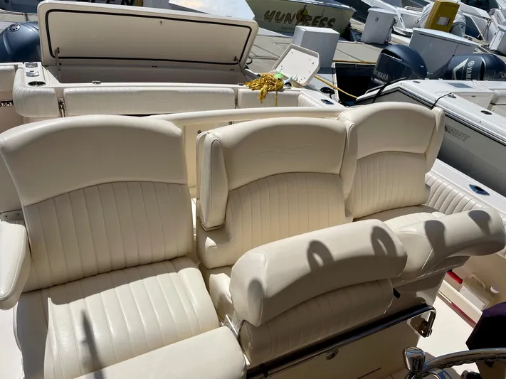  Yacht Photos Pics Luxurious seating on a 2012 Grady-White Canyon 336 boat, docked with engines visible.