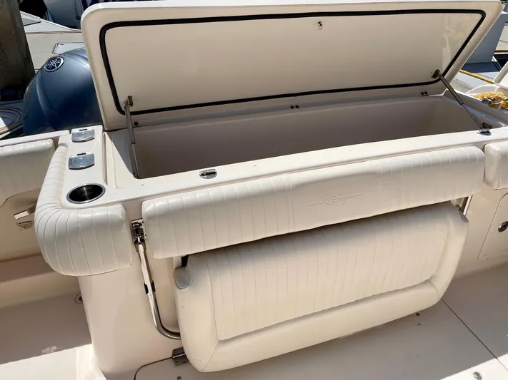  Yacht Photos Pics 2012 Grady-White Canyon 336 boat with open storage compartment and cushioned seating.