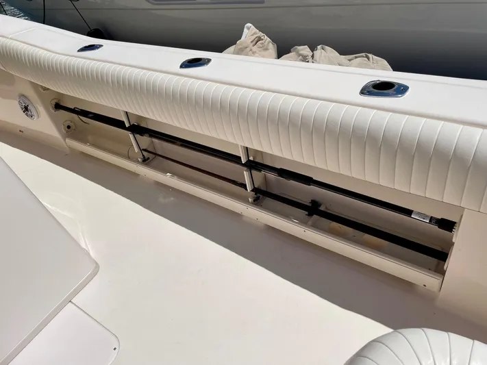  Yacht Photos Pics 2012 Grady-White Canyon 336 boat interior with cushioned seating and rod storage.