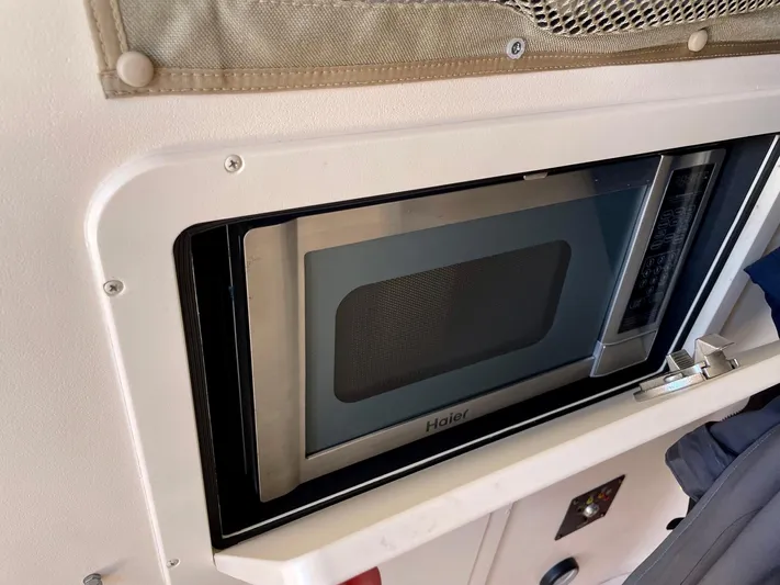  Yacht Photos Pics Built-in Haier microwave inside a 2012 Grady-White Canyon 336 boat cabin.