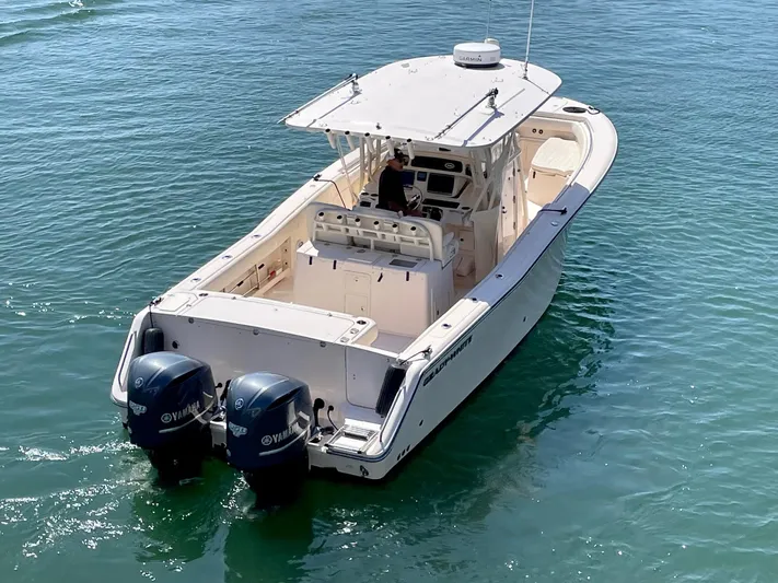  Yacht Photos Pics 2012 Grady-White Canyon 336 boat with dual Yamaha engines on clear water.