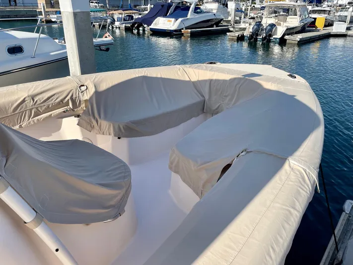  Yacht Photos Pics 2012 Grady-White Canyon 336 boat with covered seating at a marina.