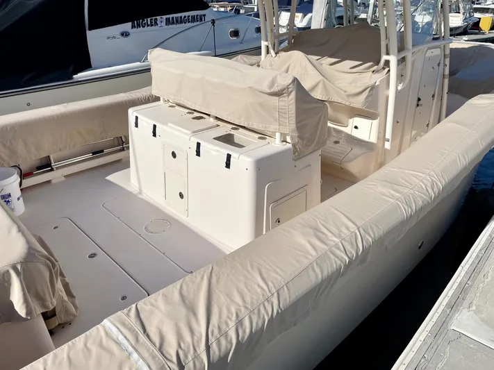  Yacht Photos Pics 2012 Grady-White Canyon 336 boat interior with beige seating and storage compartments.