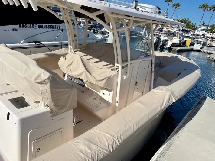  Yacht Photos Pics 2012 Grady-White Canyon 336 boat docked, featuring beige covers and spacious seating.