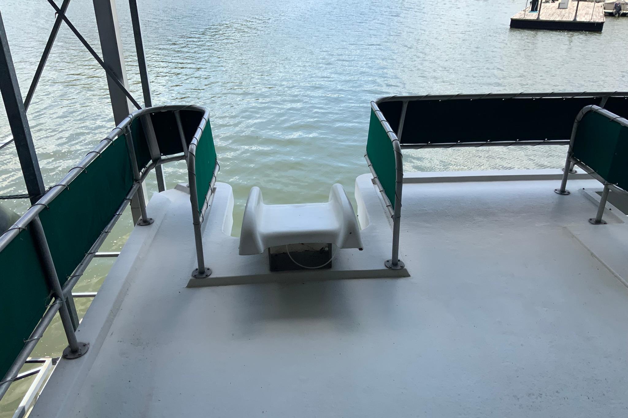 Rear deck of 1997 Lakeview 16 x 65 houseboat overlooking water.