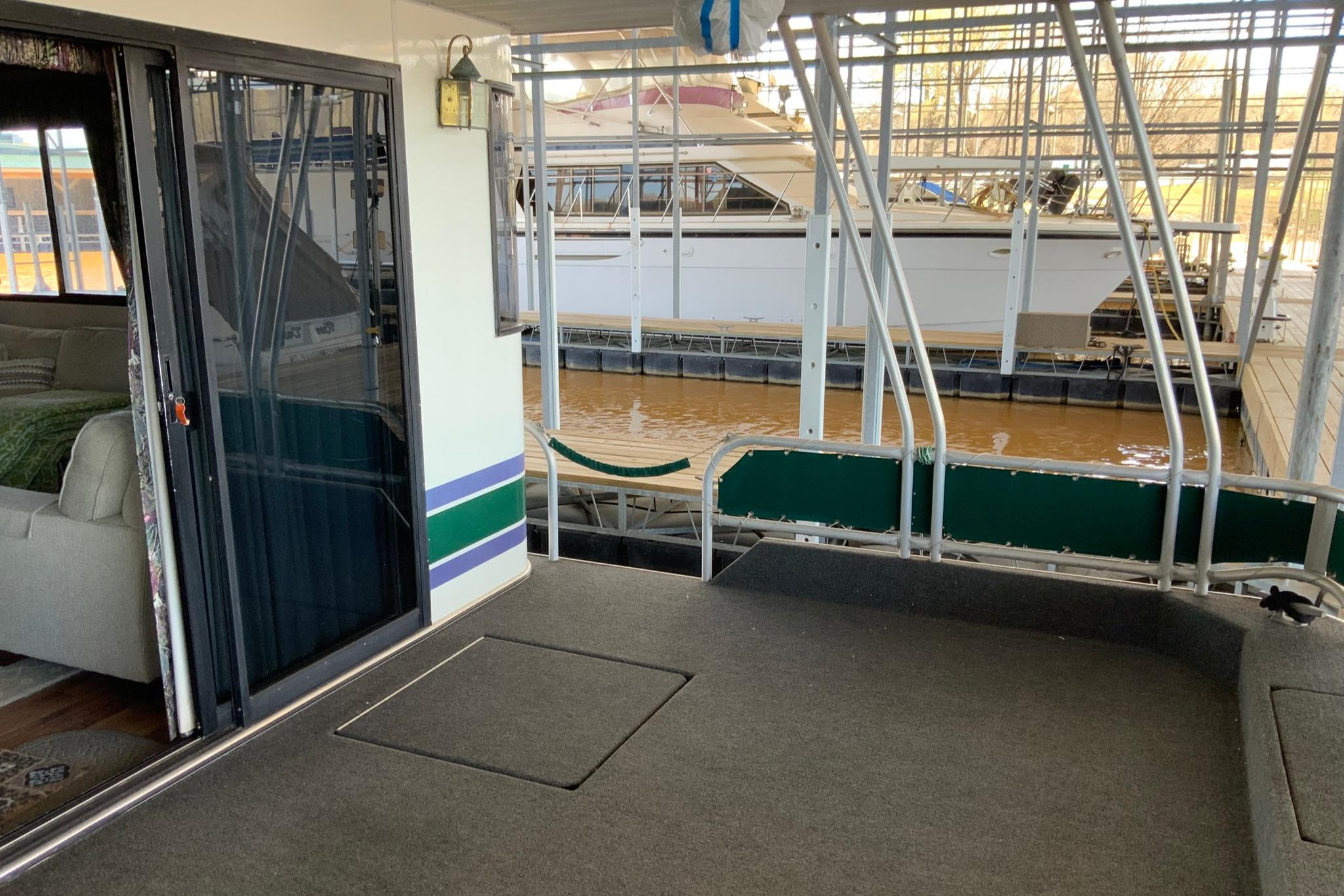 1997 Lakeview 16 x 65 houseboat interior with dock view, featuring sliding glass door.