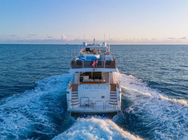 Two Seas Yacht Photos Pics Hargrave Flybridge 2001 yacht cruising on open sea at sunset.