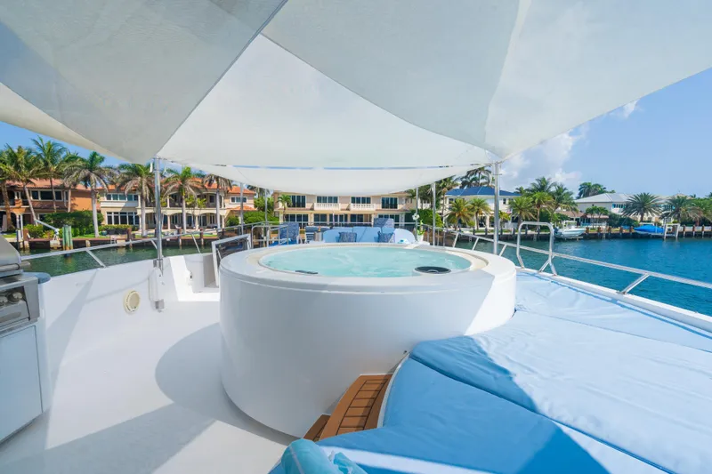Two Seas Yacht Photos Pics Luxurious 2001 Hargrave Flybridge yacht with jacuzzi, shaded deck, and waterfront view.
