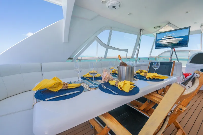 Two Seas Yacht Photos Pics Luxurious dining setup on 2001 Hargrave Flybridge yacht with ocean view.