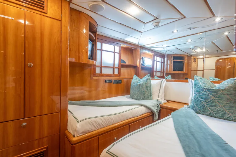 Two Seas Yacht Photos Pics Luxurious 2001 Hargrave Flybridge yacht cabin with elegant wood finish and cozy bedding.
