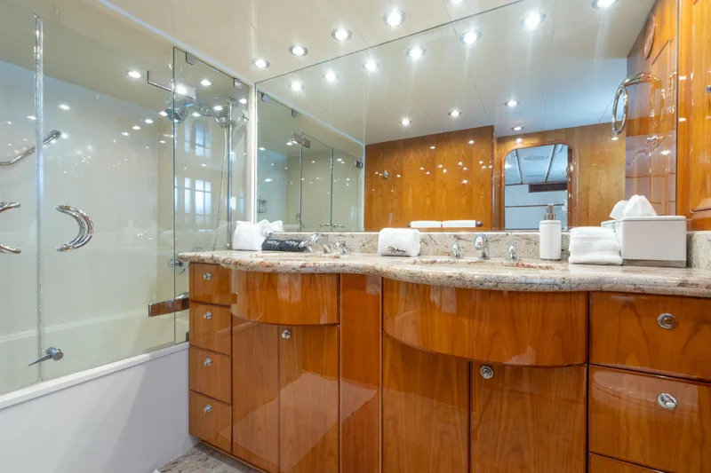 Two Seas Yacht Photos Pics Luxurious bathroom on 2001 Hargrave Flybridge yacht with elegant wood cabinetry and marble countertop.