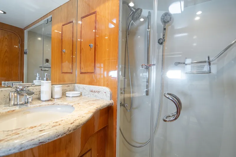 Two Seas Yacht Photos Pics Luxurious bathroom in 2001 Hargrave Flybridge yacht with marble countertop and glass shower.