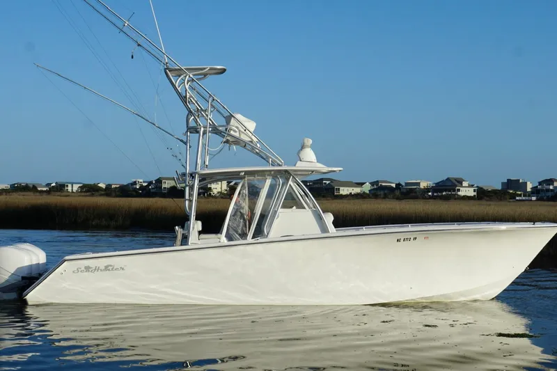  Yacht Photos Pics 2017 SeaHunter 35 Tournament boat on calm water, coastal houses in background.