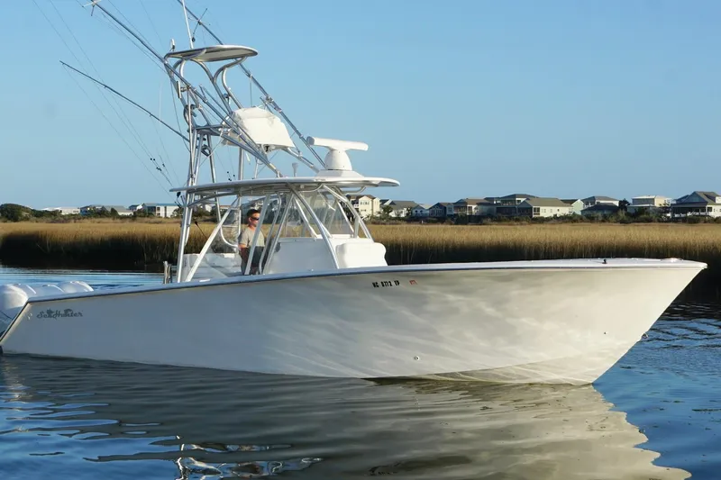  Yacht Photos Pics 2017 SeaHunter 35 Tournament boat on calm water near coastal homes.
