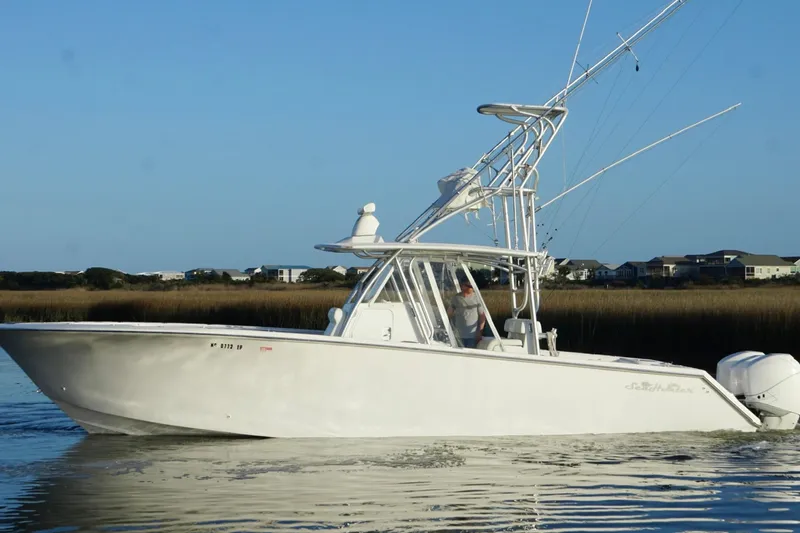  Yacht Photos Pics 2017 SeaHunter 35 Tournament boat cruising on calm water near shoreline.