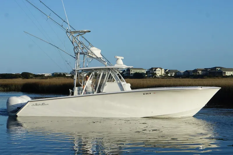  Yacht Photos Pics 2017 SeaHunter 35 Tournament boat on calm water, coastal homes in background.