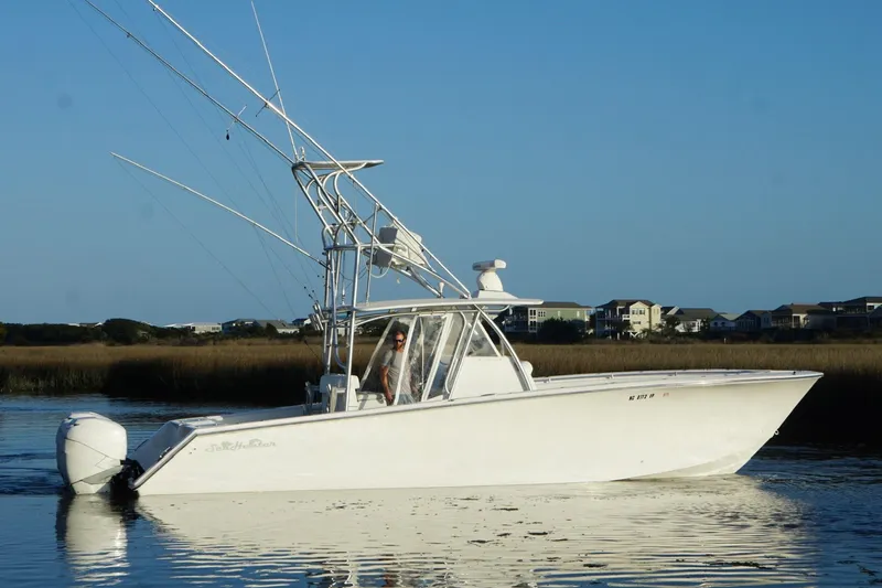  Yacht Photos Pics 2017 SeaHunter 35 Tournament boat on calm water with coastal homes in the background.